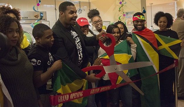 Moments before Island Soul is revealed, students pivotal to the restaurant's creation prepare to cut the ribbon. Photo by Janelle Clausen.