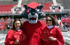 Graduates pose with Wolfie. Photo by Kayla Shults.