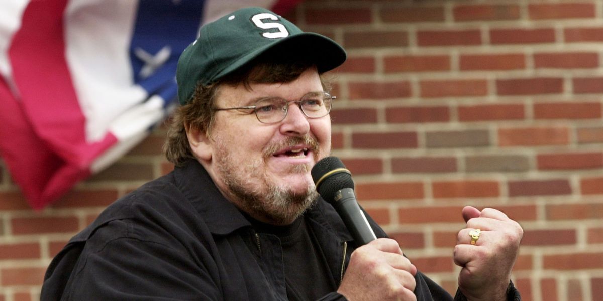 BOSTON - JULY 27:  Filmmaker Michael Moore addresses a crowd of people who couldn't get inside a packed "Take America Back" conference at the Royal Sonesta Hotel in Boston, Massachusetts. Moore was in Boston to appear at several events during the Democratic National Convention.  (Photo by Michael Springer/Getty Images)