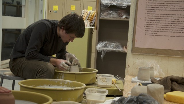 Stony Brook University student David Ackerman makes a pottery mug in the university Craft Center.  (Oct., 2013.) Photo by Devan Valoroso.