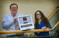 Ken Lindblom, director of the English Teacher Education Program and Amy Margolies, assistant director, with a slide of a digital badge that students in the School of Professional Development at Stony Brook University may now earn. Photo courtesy of SBU News Desk.